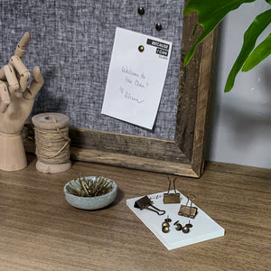 boho desk decor scene antiqued brass thumbtacks paper clips binder clips wood hand wood spool concrete dish linen pin board with pallet-wood frame